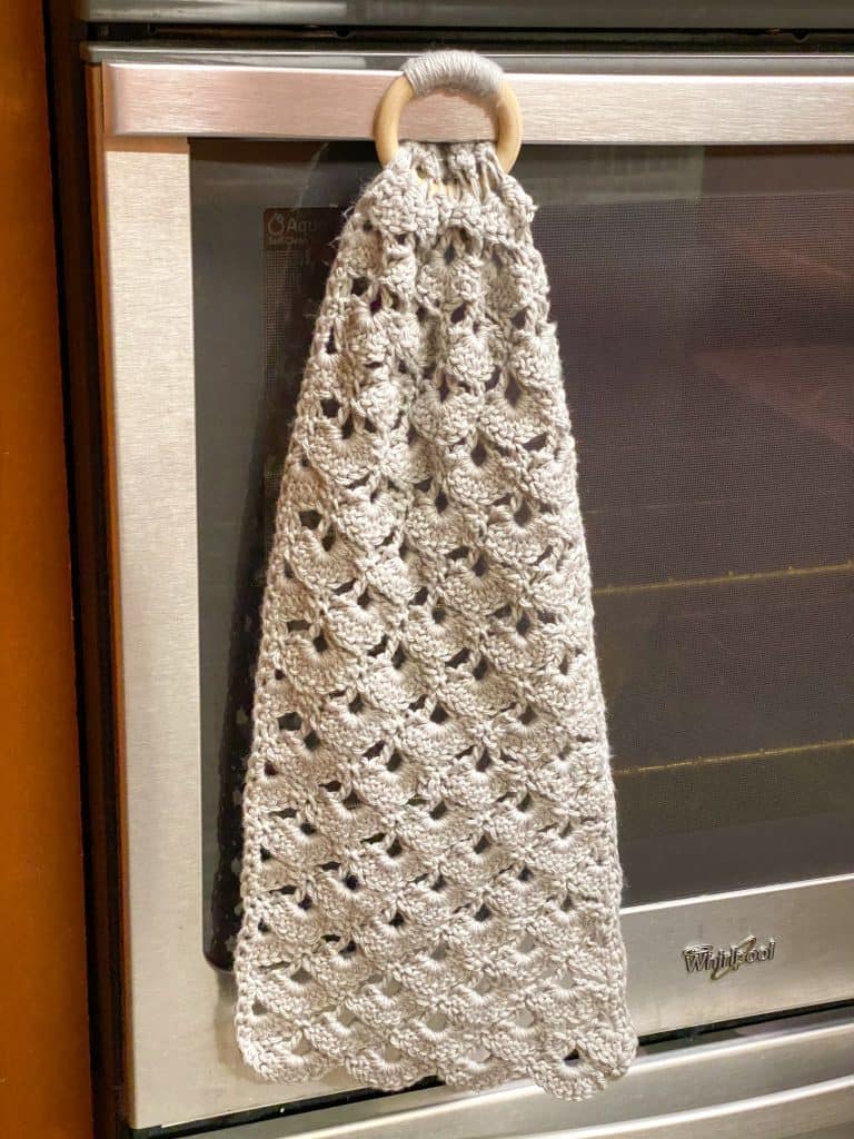 This decorative dish towel makes a great gift! The wooden ring makes this towel super easy to attach to your oven or dishwasher. Using I Love this Cotton yarn from Hobby Lobby or any other 100% cotton yarn.